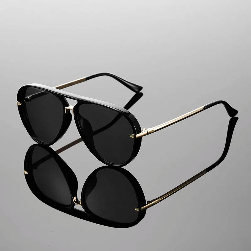 Close-up detail of gold-tone arm and gradient lens transition