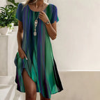 Women wearing green and blue striped midi dress, full-length front view