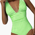Women's green and white striped one piece swimsuit with plunging neckline, front view
