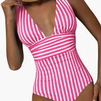 Model in striped swimsuit, full length pose from front angle