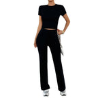 Overhead flat lay of grey marl crop top and trousers folded together