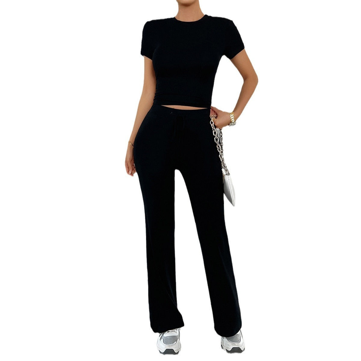 Overhead flat lay of grey marl crop top and trousers folded together