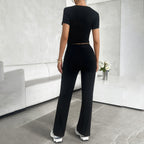 Model in cropped top and wide leg trousers set, side profile pose