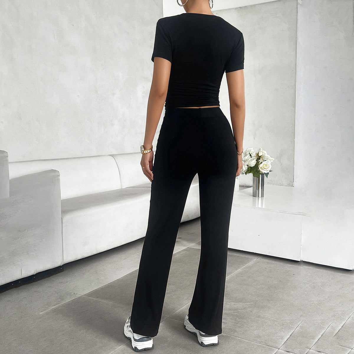 Model in cropped top and wide leg trousers set, side profile pose