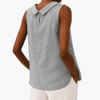 Model wearing sleeveless collared top, three-quarter pose