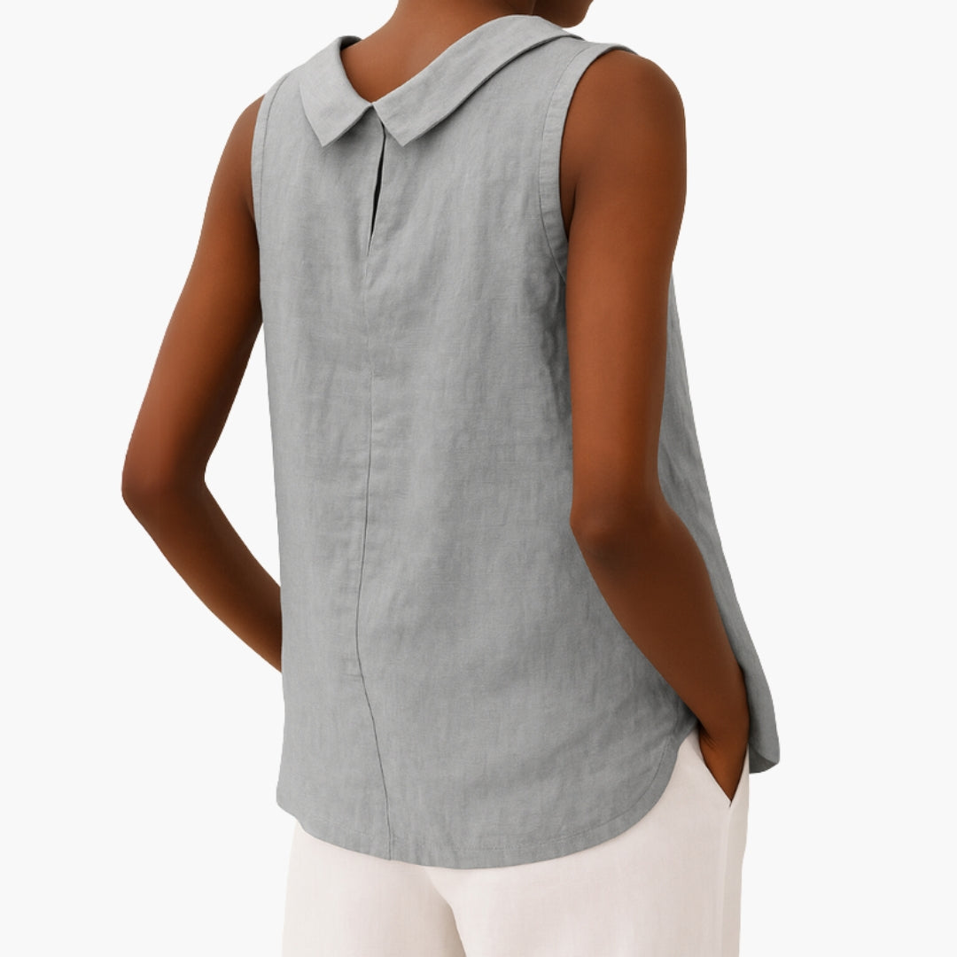 Model wearing sleeveless collared top, three-quarter pose