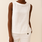 Model in sleeveless top, three-quarter pose with arms down