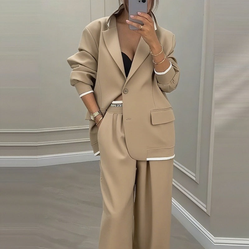 Rear view of grey blazer and trousers set on model