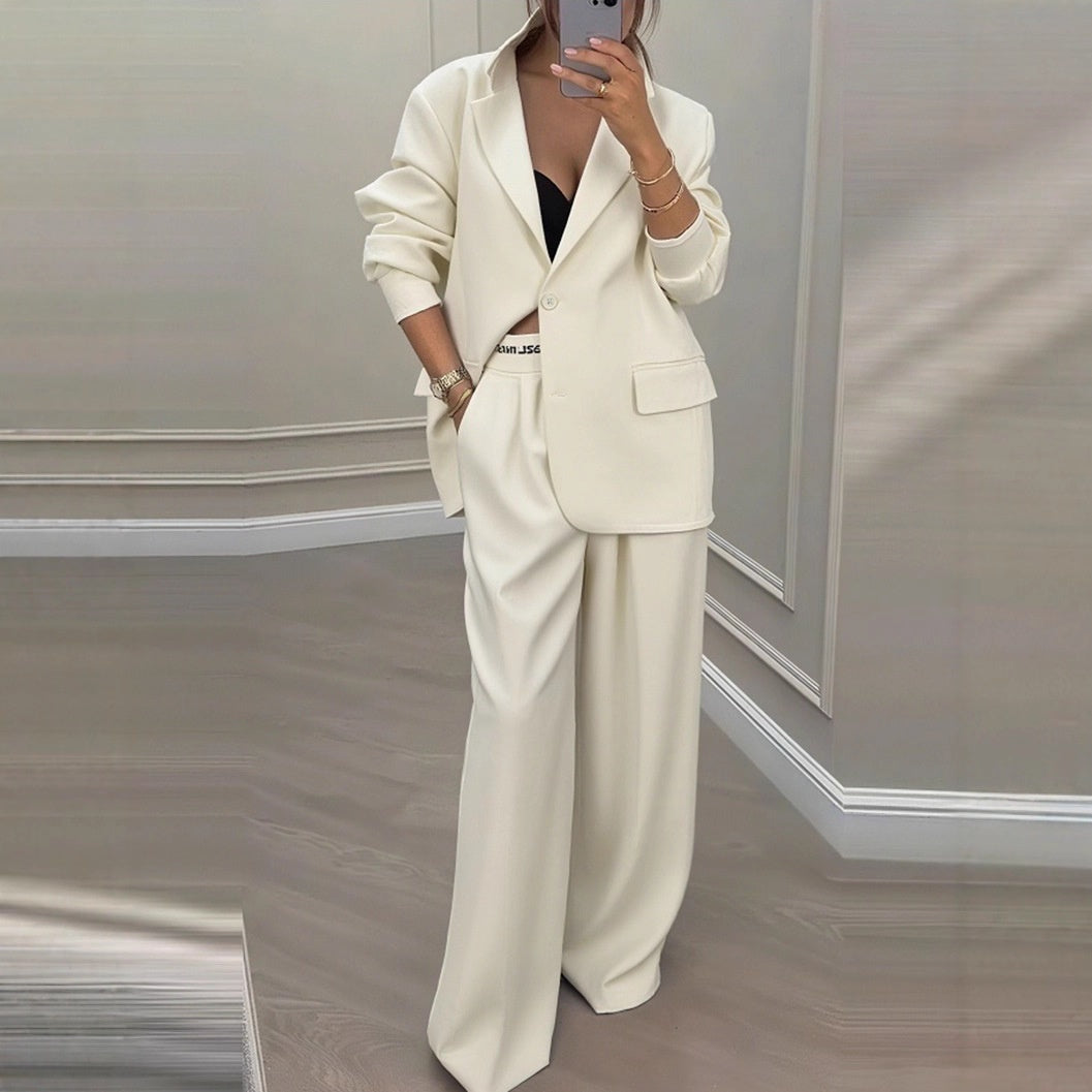 Model wearing grey blazer and wide leg trousers, front pose