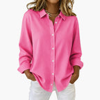 Women's hot pink long sleeve collared shirt, front view on flat lay