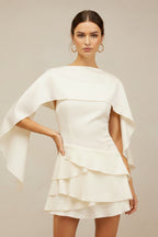 Close-up of dramatic cape overlay and fitted bodice detail