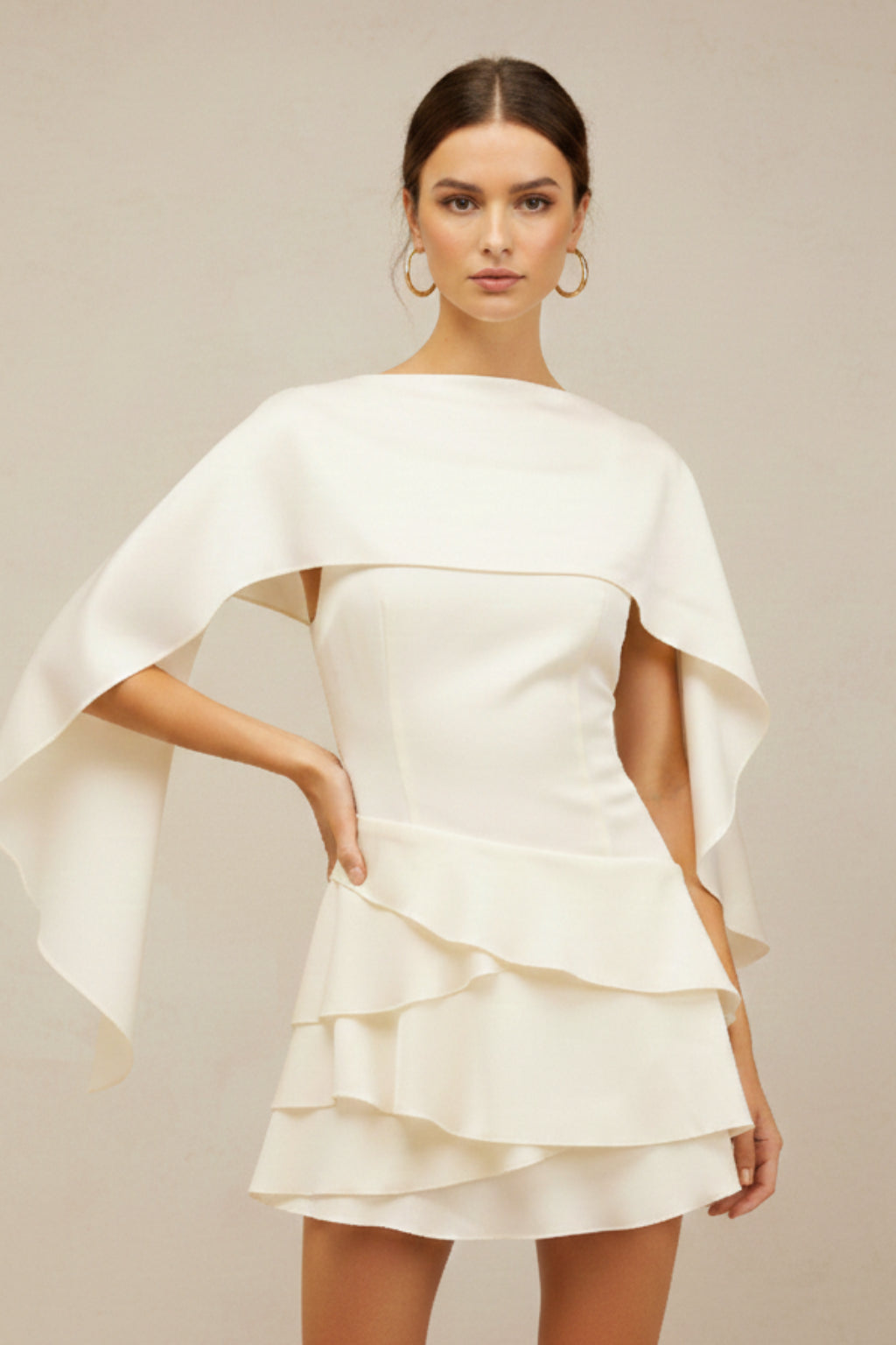 Close-up of dramatic cape overlay and fitted bodice detail