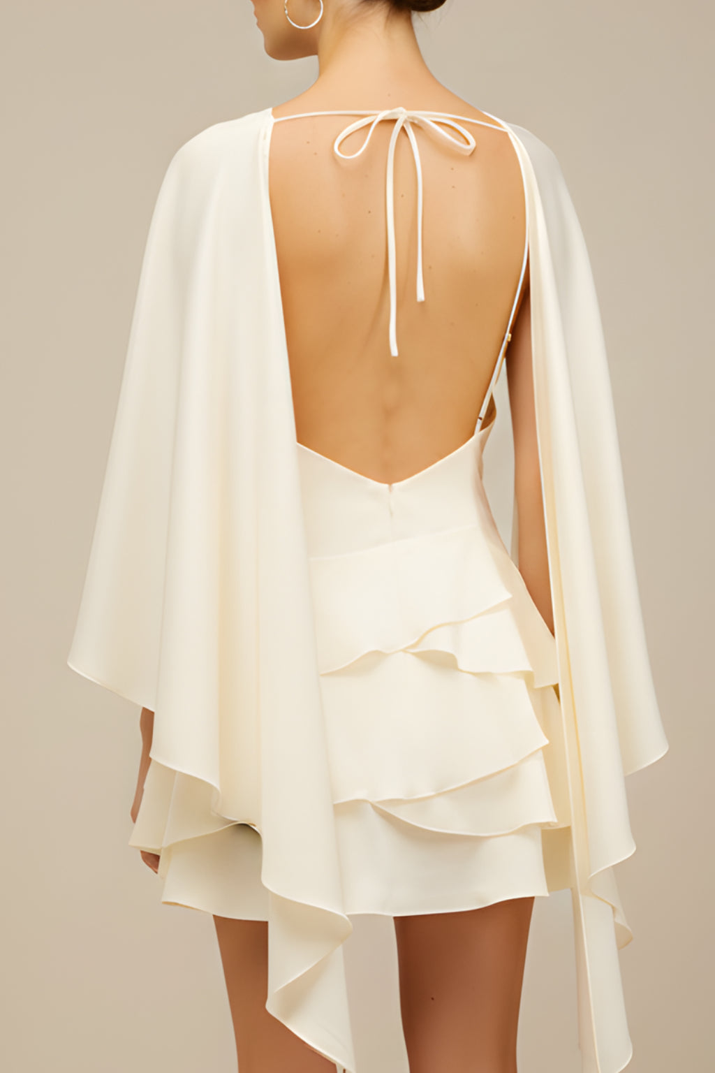 Back view of cape sleeve dress with draping detail