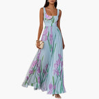 Back view of maxi dress featuring wide straps and flowing pleated skirt
