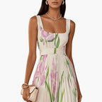 Side profile of floral maxi dress showing A-line pleated skirt and fitted bodice