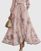 Model from behind showing back drape of pleated maxi dress