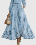 Floral print detail on muted-tone maxi dress fabric