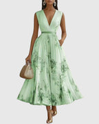 Full-length portrait of woman in floral sleeveless maxi dress