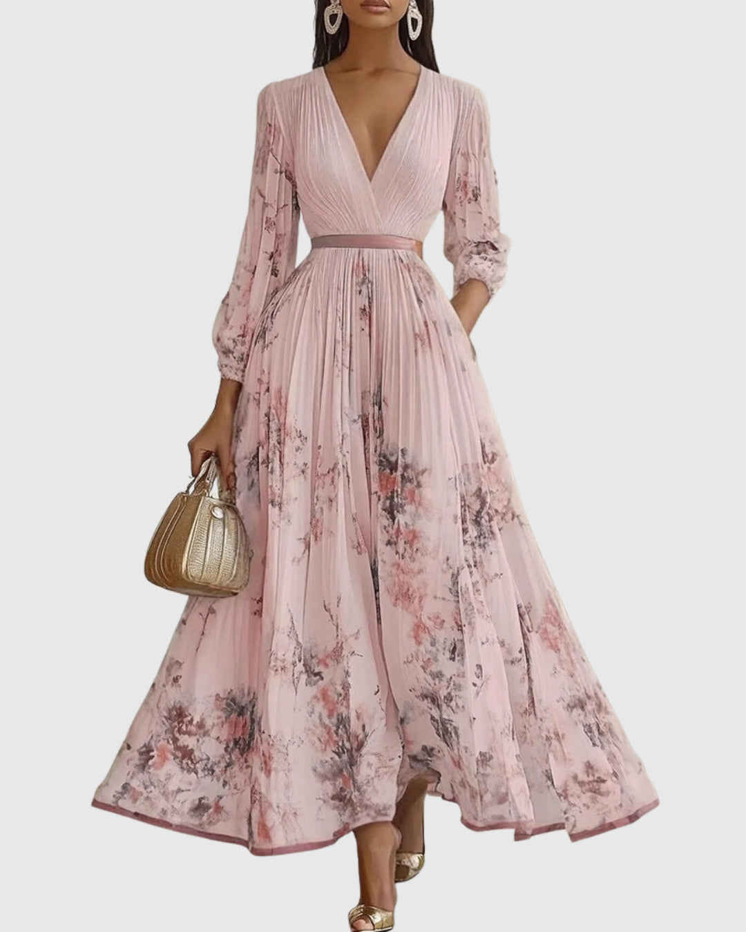 Hem detail of flowing pleated maxi dress on model