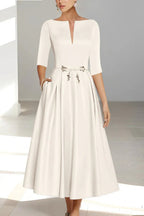 Bride in pleated A-line midi wedding dress, full-length pose