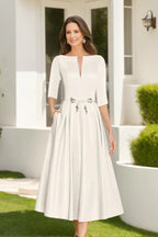 Close-up of embellished waist tie detail on midi wedding dress