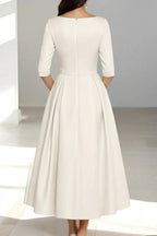 Back view of half sleeve midi wedding dress with pleated skirt