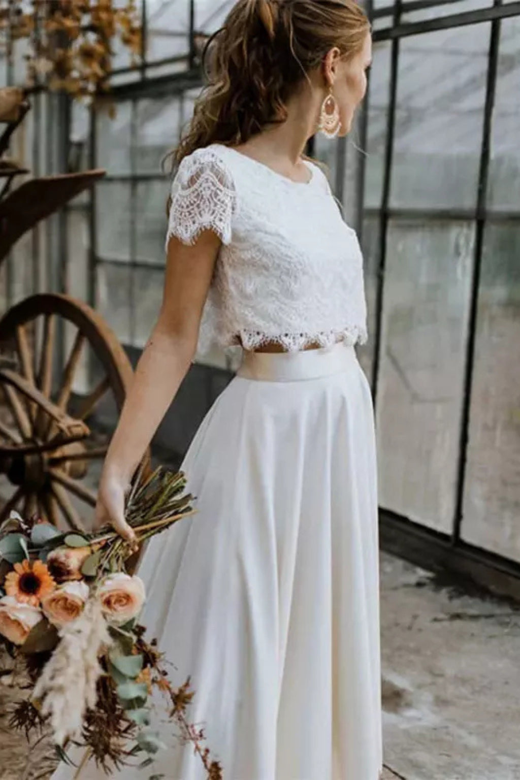 Back view of ivory lace crop top and flowing maxi skirt
