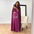 Side profile of floor-length maxi dress showing flowing silhouette