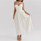 Model wearing pleated strapless dress, full-length pose