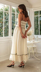 Side profile showing gathered waist and tiered ruffle hem
