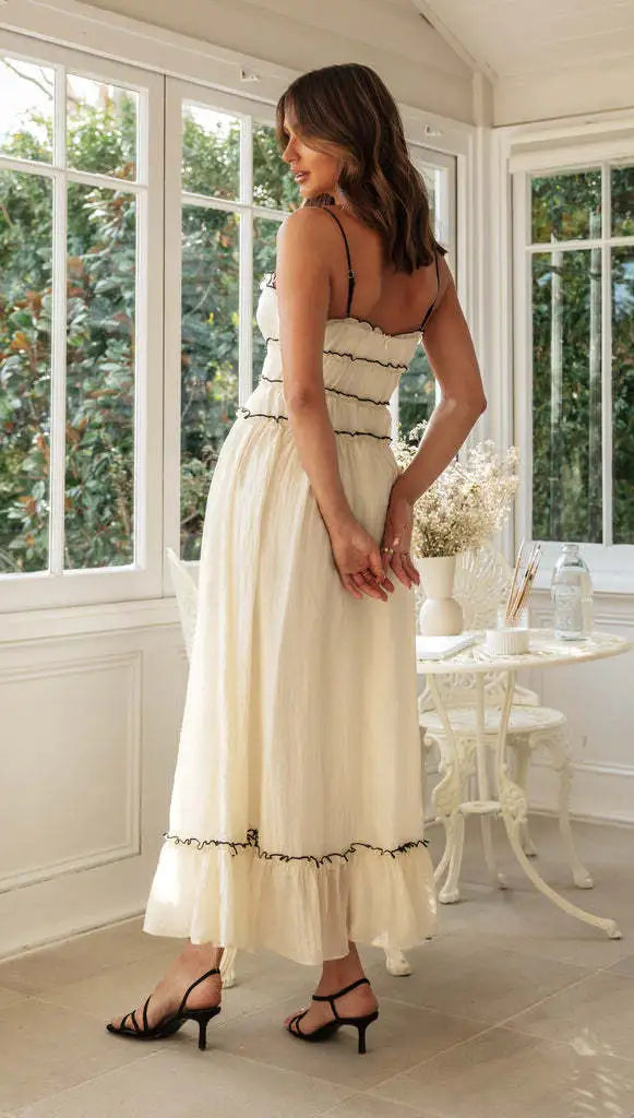 Side profile showing gathered waist and tiered ruffle hem