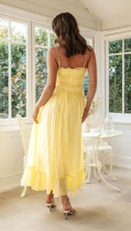 Full-length pose showing flowing skirt and wedding guest styling