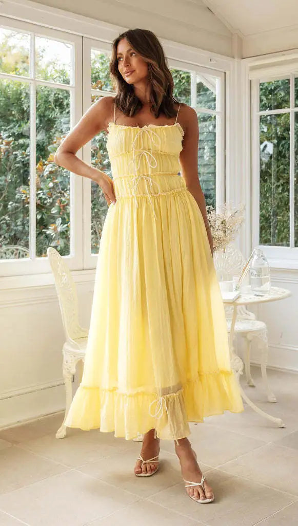 Back view displaying lace-up ties and cascading ruffle tiers