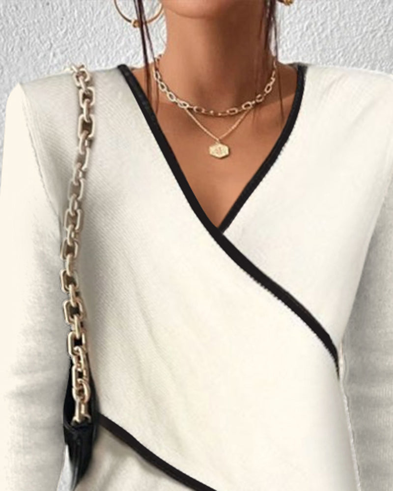 Woman wearing ivory wrap jumper, side profile showing waist definition