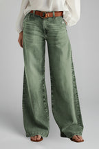 Model wearing khaki green wide leg jeans with high-rise waistband, front view