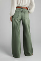 Side profile of khaki green denim jeans showing silhouette and leg shape