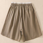 Model wearing linen shorts, full-length standing pose