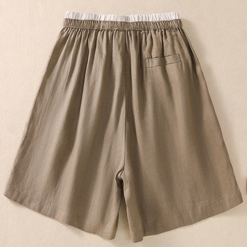 Model wearing linen shorts, full-length standing pose