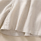 Model sitting, showing drape and fit of shorts