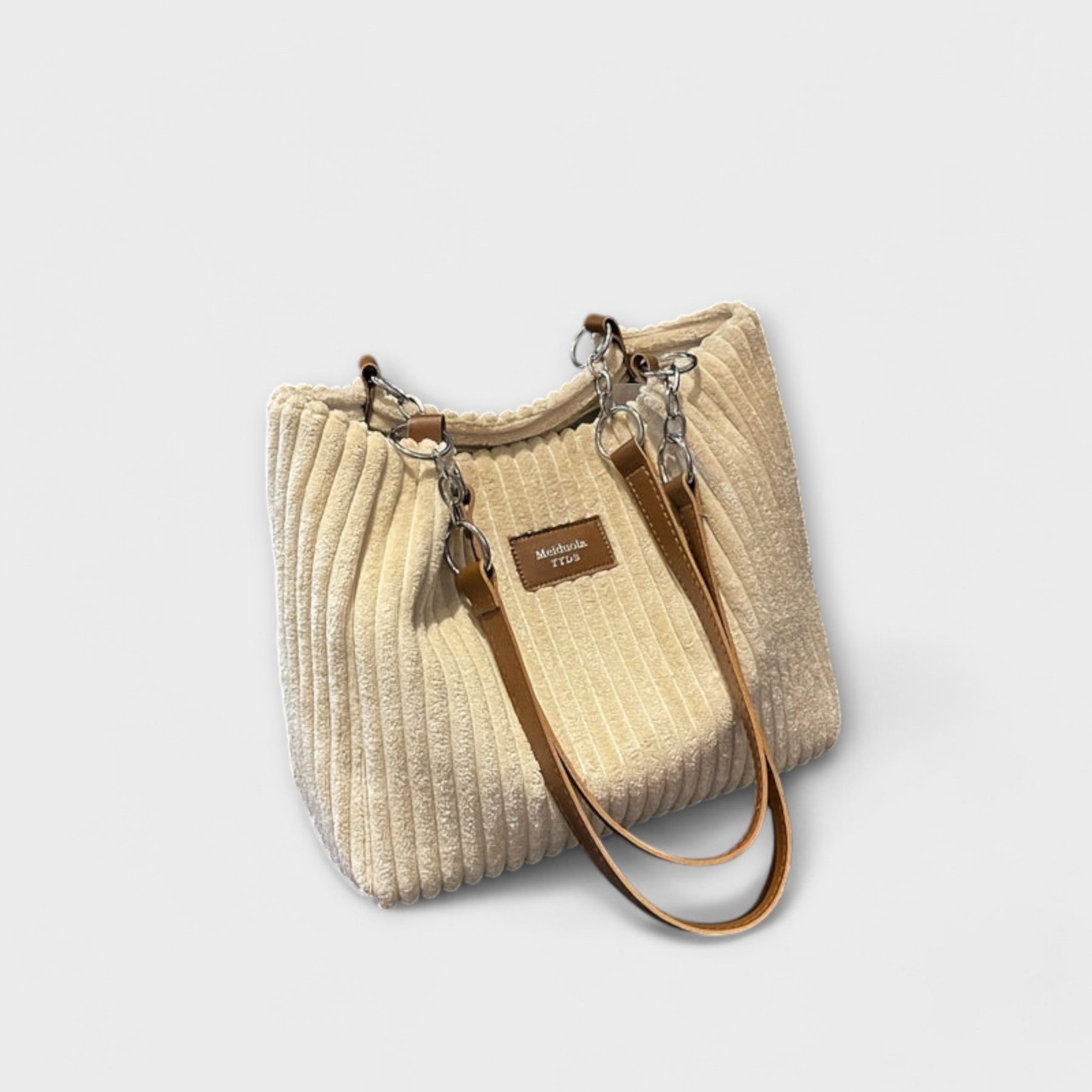 Back view of corduroy bag showing chain and strap details
