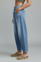 Close-up detail of tapered ankle and barrel leg shape on denim jeans