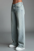 Back view of light blue denim jeans showing straight leg cut