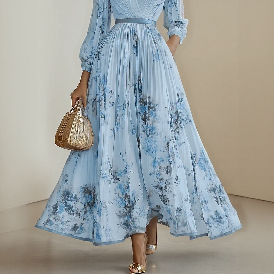 Three-quarter view of model in floral pleated dress