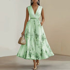 Model in floral maxi dress, back view showing pleats