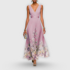 Model posing in floral maxi dress showing side profile and draping