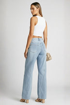 Model in light blue straight leg jeans styled for smart-casual look