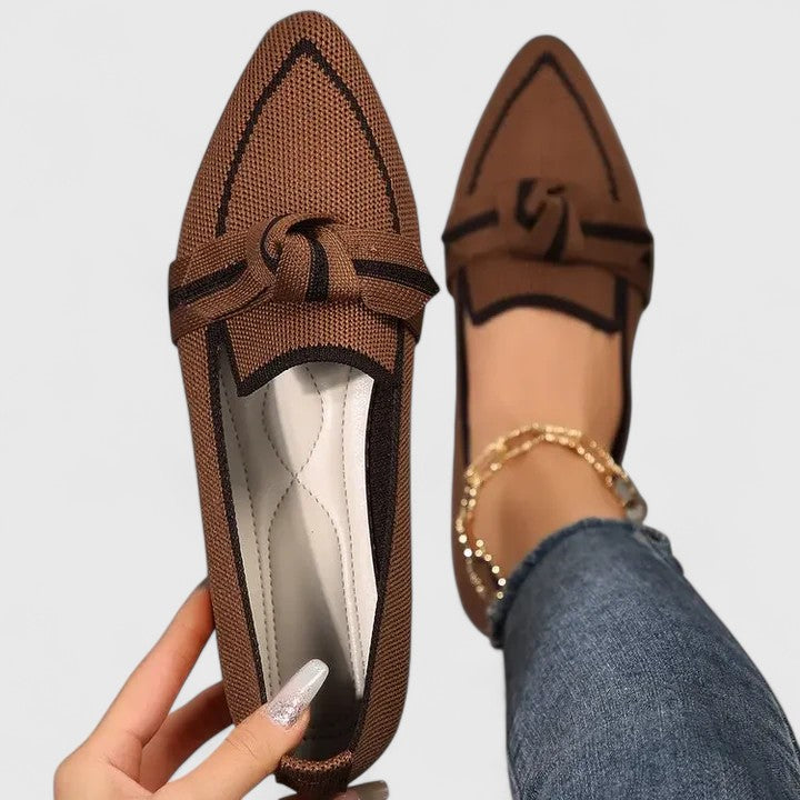 Close-up of delicate knotted bow and contrast piping on loafer upper