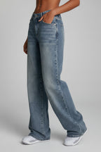 Close-up of light blue denim fabric showing subtle fading detail