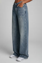 Light blue wide leg jeans draped on model, full length shot