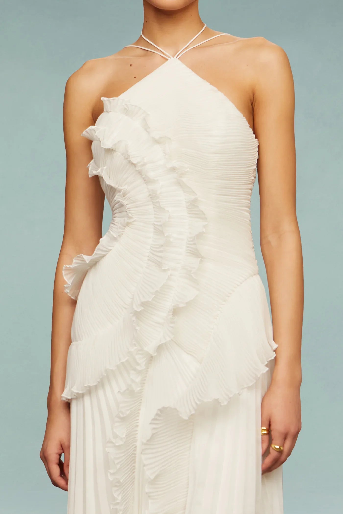 Full-length standing pose wearing pleated ruffle halter maxi dress